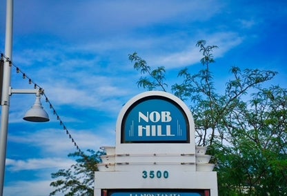 Nob Hill neighborhood welcome sign surrounded by trees